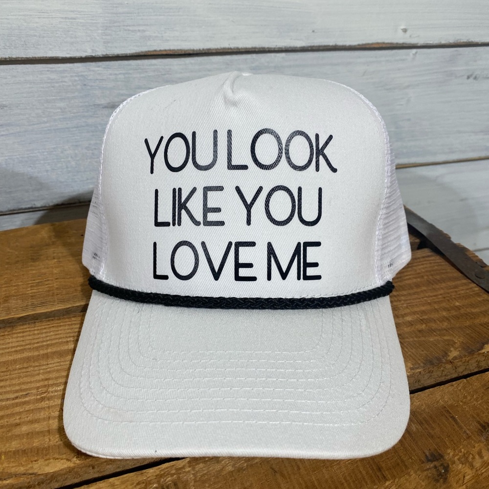 White Trucker Hat with Black Text “You look like you love me”
